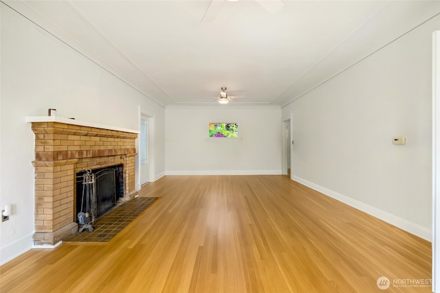 4918 S 3rd Ave, Everett, WA 98203 - unfurnished living room with ceiling fan, light wood-style flooring, a brick fireplace, and crown molding
