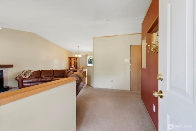 25320 153rd St E, Buckley, WA 98321 - living room with light colored carpet, a chandelier, vaulted ceiling, and a tiled fireplace