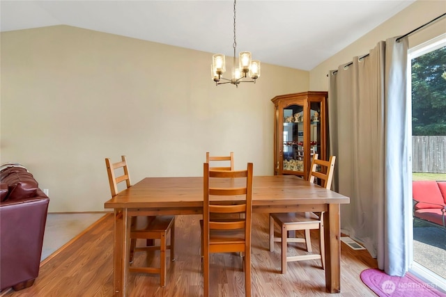 25320 153rd St E, Buckley, WA 98321 - dining area featuring vaulted ceiling, light wood-style flooring, and a chandelier