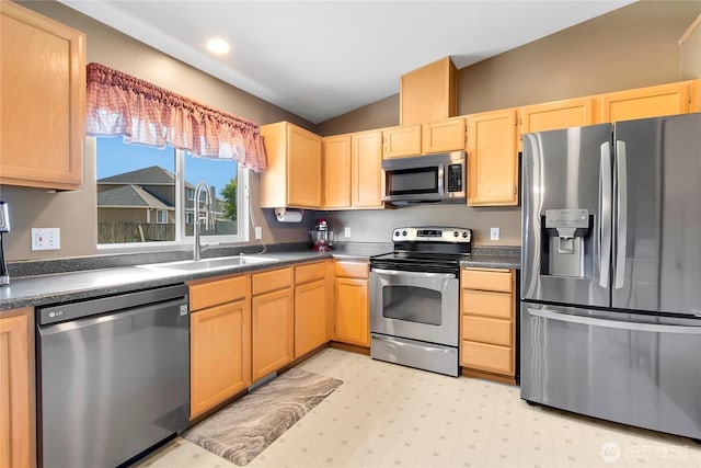 25320 153rd St E, Buckley, WA 98321 - kitchen featuring stainless steel appliances, a sink, lofted ceiling, light brown cabinets, and dark countertops