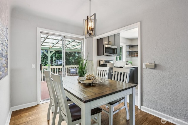 1535 NE 107th St, Seattle, WA 98125 - dining area featuring a chandelier and light wood-type flooring