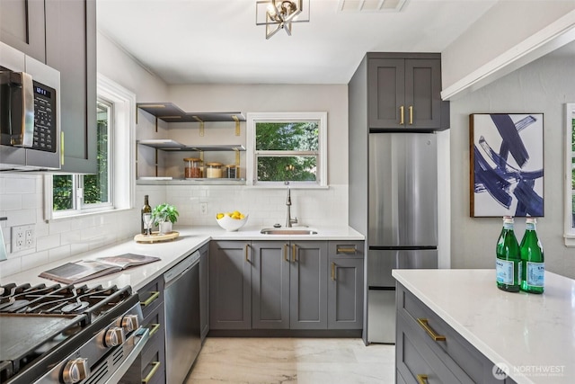 1535 NE 107th St, Seattle, WA 98125 - kitchen featuring stainless steel appliances, decorative backsplash, healthy amount of natural light, and light countertops