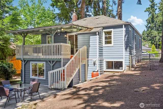 1535 NE 107th St, Seattle, WA 98125 - back of property with a chimney, stairway, and a patio