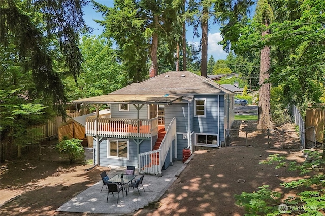 1535 NE 107th St, Seattle, WA 98125 - rear view of property with a fenced backyard, a gate, stairway, a wooden deck, and a patio