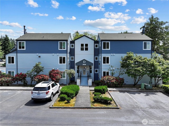 20320 Bothell-Everett Hwy Unit D204, Bothell, WA 98012 - view of front facade featuring uncovered parking