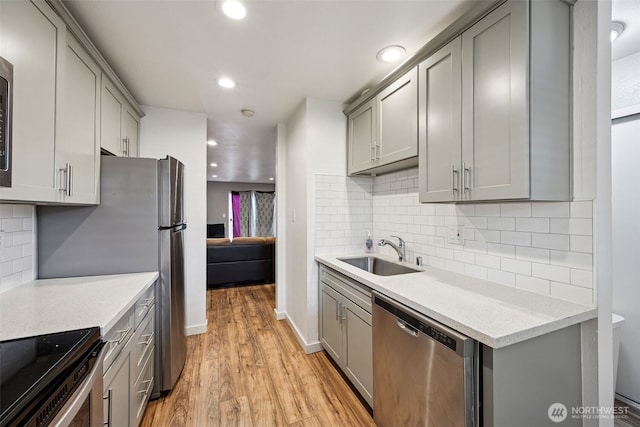 12416 SE 272nd Pl Unit C, Kent, WA 98030 - kitchen featuring appliances with stainless steel finishes, gray cabinetry, light wood-style flooring, light countertops, and recessed lighting