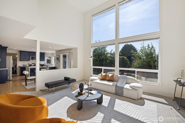 7109 SE 135th Pl, Newcastle, WA 98059 - living room featuring a towering ceiling and light wood-style floors