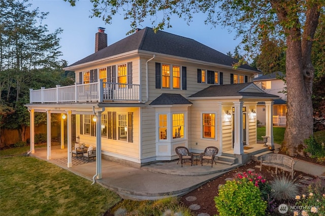 8816 Fauntleroy Way SW, Seattle, WA 98136 - back of property with a chimney, a patio, a balcony, and a shingled roof