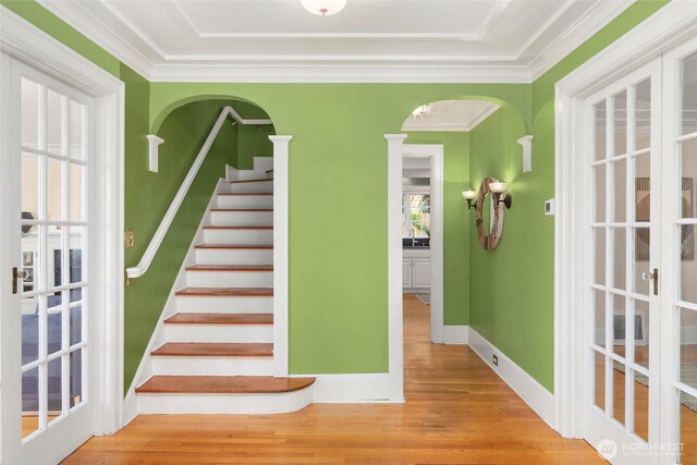 8816 Fauntleroy Way SW, Seattle, WA 98136 - stairway with wood finished floors, arched walkways, crown molding, and french doors