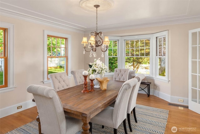 8816 Fauntleroy Way SW, Seattle, WA 98136 - dining space with a chandelier, light wood-type flooring, and crown molding