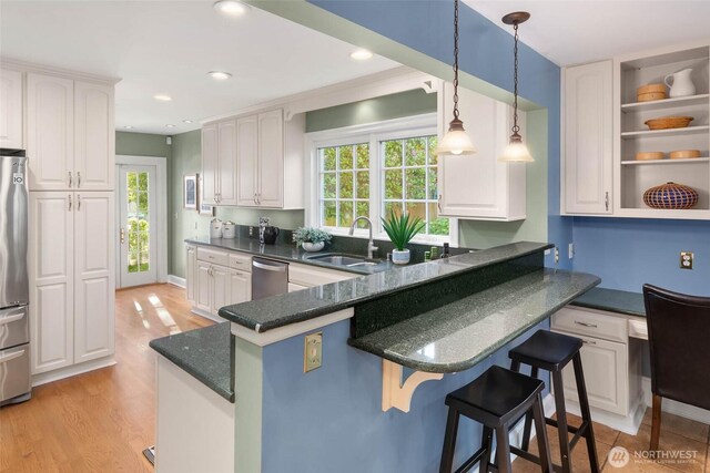 8816 Fauntleroy Way SW, Seattle, WA 98136 - kitchen featuring stainless steel appliances, a breakfast bar area, white cabinetry, and recessed lighting