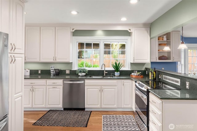 8816 Fauntleroy Way SW, Seattle, WA 98136 - kitchen featuring appliances with stainless steel finishes, white cabinets, light wood finished floors, and recessed lighting