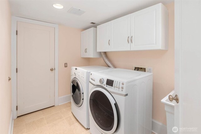 8816 Fauntleroy Way SW, Seattle, WA 98136 - laundry area featuring cabinet space, washing machine and dryer, and light tile patterned flooring