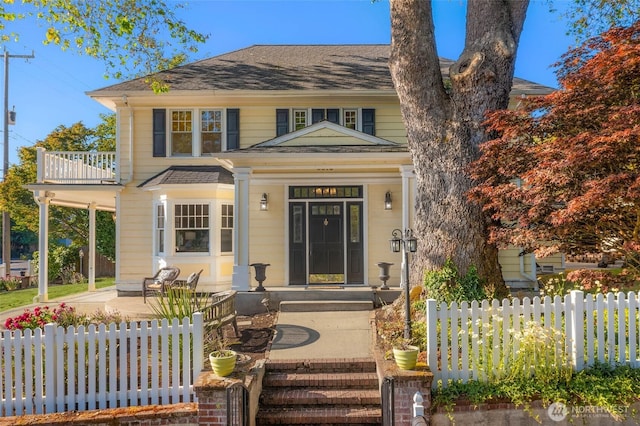 8816 Fauntleroy Way SW, Seattle, WA 98136 - view of front facade with a porch, a shingled roof, and a balcony