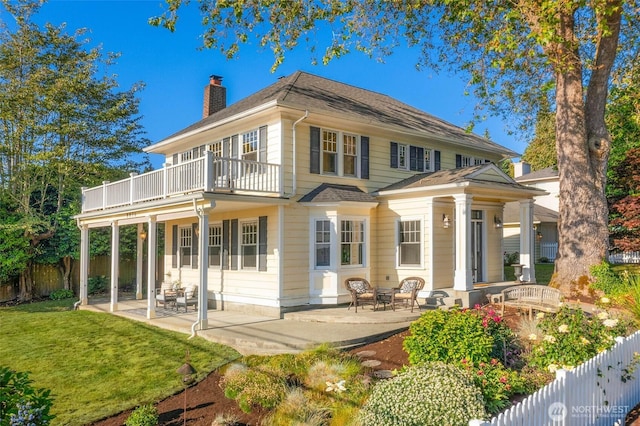 8816 Fauntleroy Way SW, Seattle, WA 98136 - back of property featuring a balcony, a chimney, and a patio area