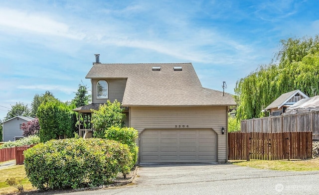 3304 202nd St SW, Lynnwood, WA 98036 - view of home's exterior with asphalt driveway, roof with shingles, and an attached garage