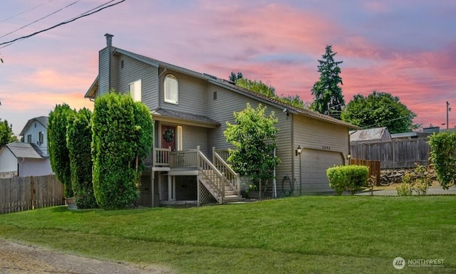 3304 202nd St SW, Lynnwood, WA 98036 - back of property at dusk featuring a chimney, an attached garage, stairway, driveway, and a deck