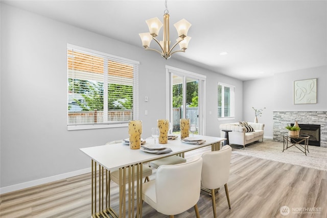 3410 102nd Ave NE, Lake Stevens, WA 98258 - dining space featuring baseboards, light wood-style flooring, a chandelier, a fireplace, and recessed lighting