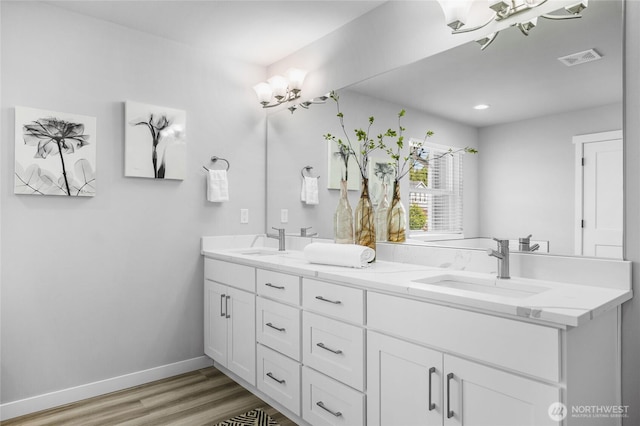 3410 102nd Ave NE, Lake Stevens, WA 98258 - bathroom with a chandelier, double vanity, wood finished floors, and baseboards