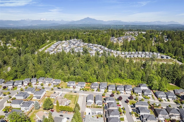 3410 102nd Ave NE, Lake Stevens, WA 98258 - aerial view of property's location with a heavily wooded area, nearby suburban area, and mountains