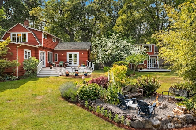 9026 SW 184th St, Vashon, WA 98070 - rear view of property featuring french doors, a fire pit, a deck, and a lawn