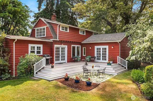 9026 SW 184th St, Vashon, WA 98070 - rear view of house featuring french doors, a deck, a lawn, and a chimney