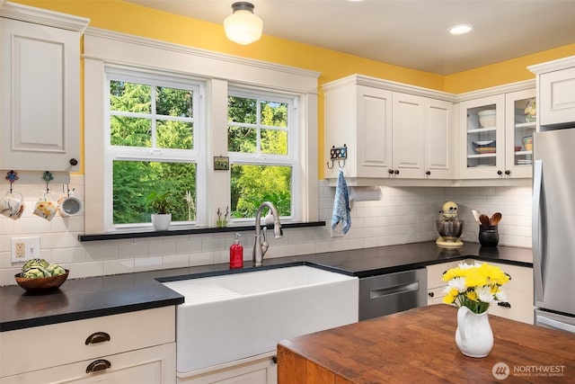 9026 SW 184th St, Vashon, WA 98070 - kitchen featuring appliances with stainless steel finishes, white cabinetry, backsplash, glass insert cabinets, and recessed lighting