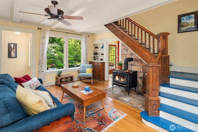 9026 SW 184th St, Vashon, WA 98070 - living area featuring stairs, a wood stove, wood finished floors, a ceiling fan, and crown molding