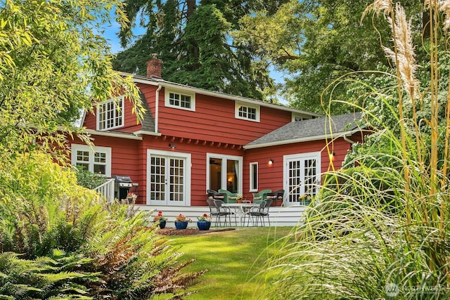 9026 SW 184th St, Vashon, WA 98070 - rear view of property with french doors, a chimney, a patio area, and a lawn