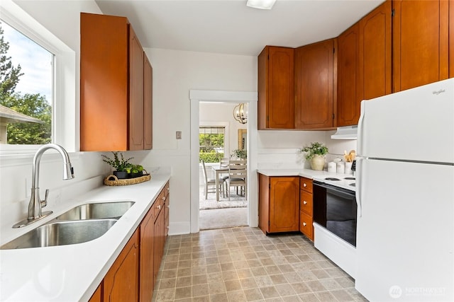 208 Barksdale Ave, Dupont, WA 98327 - kitchen featuring white appliances, under cabinet range hood, light countertops, and a chandelier
