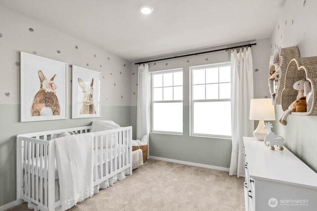 206 18th Dr Unit 104, Snohomish, WA 98290 - bedroom featuring light carpet, baseboards, and a crib