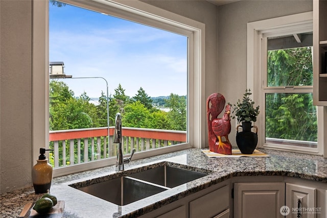7650 SE Southworth Dr, Port Orchard, WA 98366 - kitchen featuring stone countertops and a textured wall