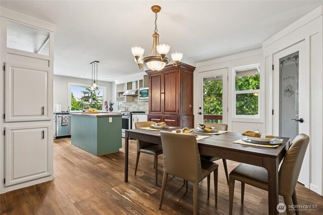 7650 SE Southworth Dr, Port Orchard, WA 98366 - dining area with wood finished floors and a chandelier