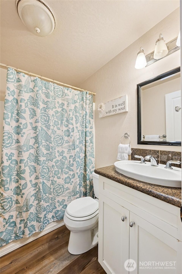 7650 SE Southworth Dr, Port Orchard, WA 98366 - bathroom featuring wood finished floors, vanity, and a shower with curtain