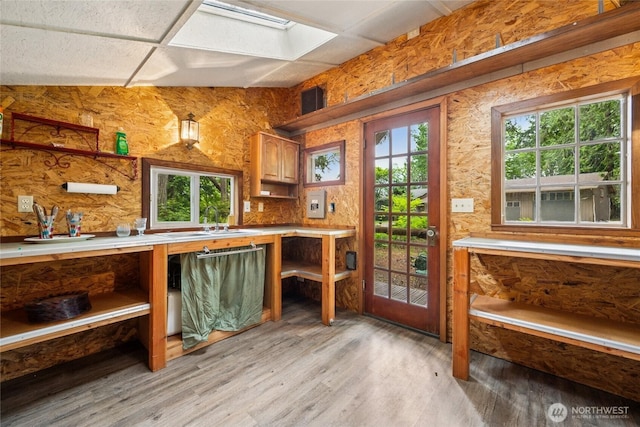 7650 SE Southworth Dr, Port Orchard, WA 98366 - kitchen with light wood-style flooring, open shelves, and light countertops