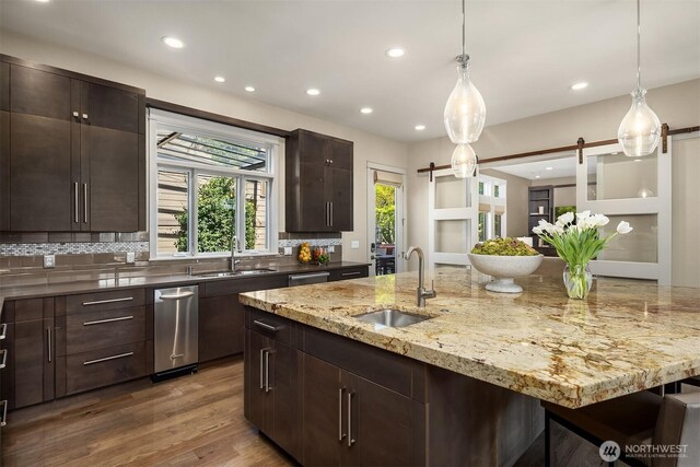 212 5th Ave W, Kirkland, WA 98033 - kitchen featuring a sink, a barn door, recessed lighting, decorative backsplash, and decorative light fixtures