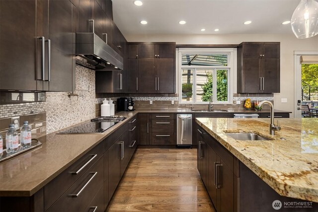 212 5th Ave W, Kirkland, WA 98033 - kitchen with black electric cooktop, a sink, recessed lighting, light wood-style flooring, and light stone counters