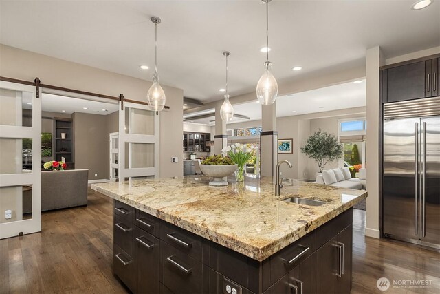 212 5th Ave W, Kirkland, WA 98033 - kitchen with built in refrigerator, open floor plan, a sink, a barn door, and recessed lighting