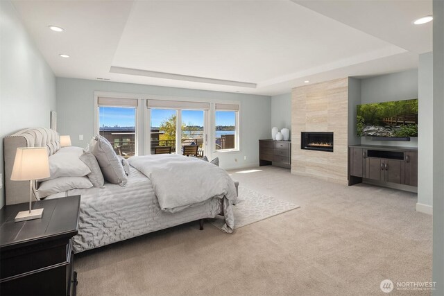 212 5th Ave W, Kirkland, WA 98033 - bedroom with a raised ceiling, carpet floors, access to outside, recessed lighting, and a tiled fireplace
