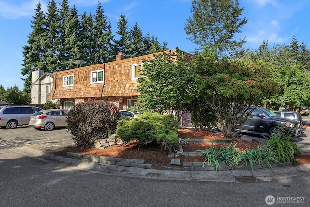 12421 5th Ave W, Everett, WA 98204 - view of front of home with mansard roof, a chimney, and brick siding