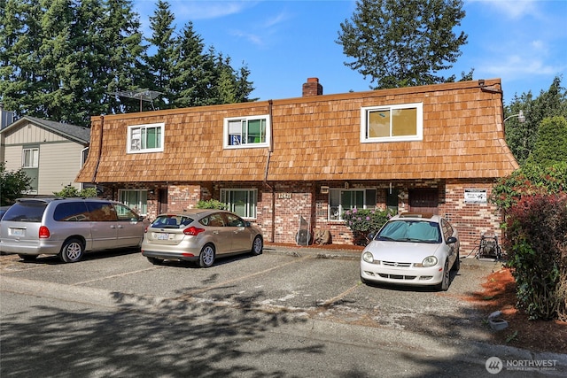 12421 5th Ave W, Everett, WA 98204 - view of property with brick siding, mansard roof, and uncovered parking