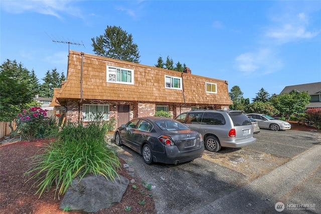 12421 5th Ave W, Everett, WA 98204 - townhome / multi-family property featuring mansard roof, brick siding, and uncovered parking