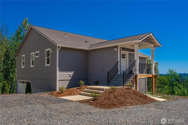 410 Studebaker Spur 1, Castle Rock, WA 98611 - view of front facade featuring an attached garage, gravel driveway, and stairs