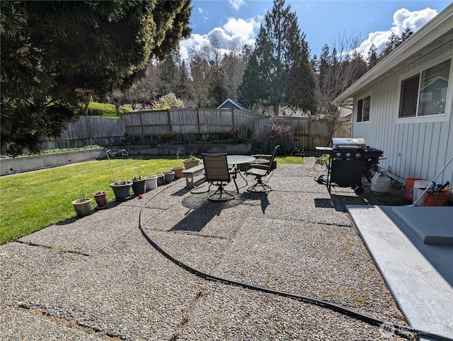 22894 Carmella Rd NW, Poulsbo, WA 98370 - fenced backyard with area for grilling, outdoor dining area, and a patio