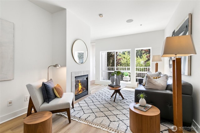 6816 NE 153rd Pl Unit D, Kenmore, WA 98028 - living area featuring a tiled fireplace, wood finished floors, and baseboards