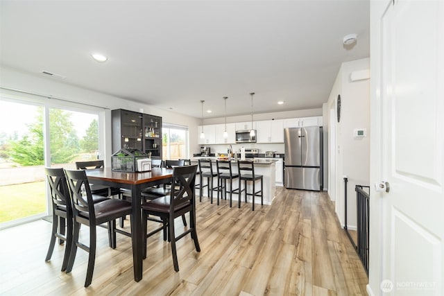15177 Prescott Loop SE, Yelm, WA 98597 - dining room with light wood-type flooring and recessed lighting