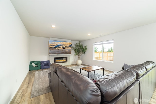 15177 Prescott Loop SE, Yelm, WA 98597 - living area with light wood-style floors, a glass covered fireplace, and recessed lighting
