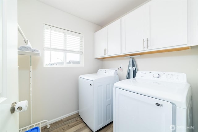 15177 Prescott Loop SE, Yelm, WA 98597 - laundry room with independent washer and dryer, cabinet space, and light wood finished floors