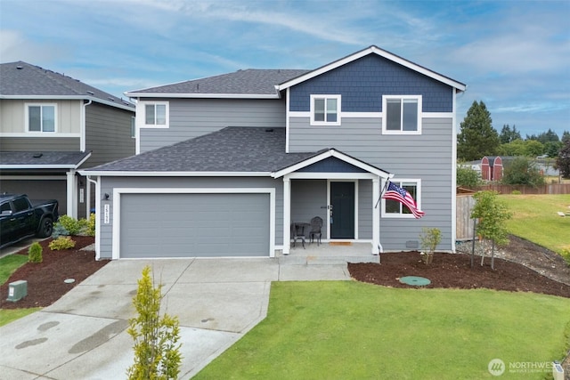 15177 Prescott Loop SE, Yelm, WA 98597 - traditional-style house featuring driveway, a front lawn, a shingled roof, and a garage