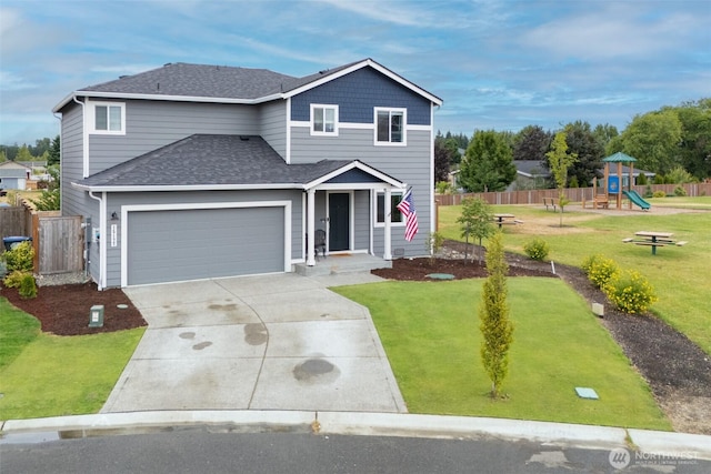 15177 Prescott Loop SE, Yelm, WA 98597 - traditional home with roof with shingles, concrete driveway, a playground, and a garage